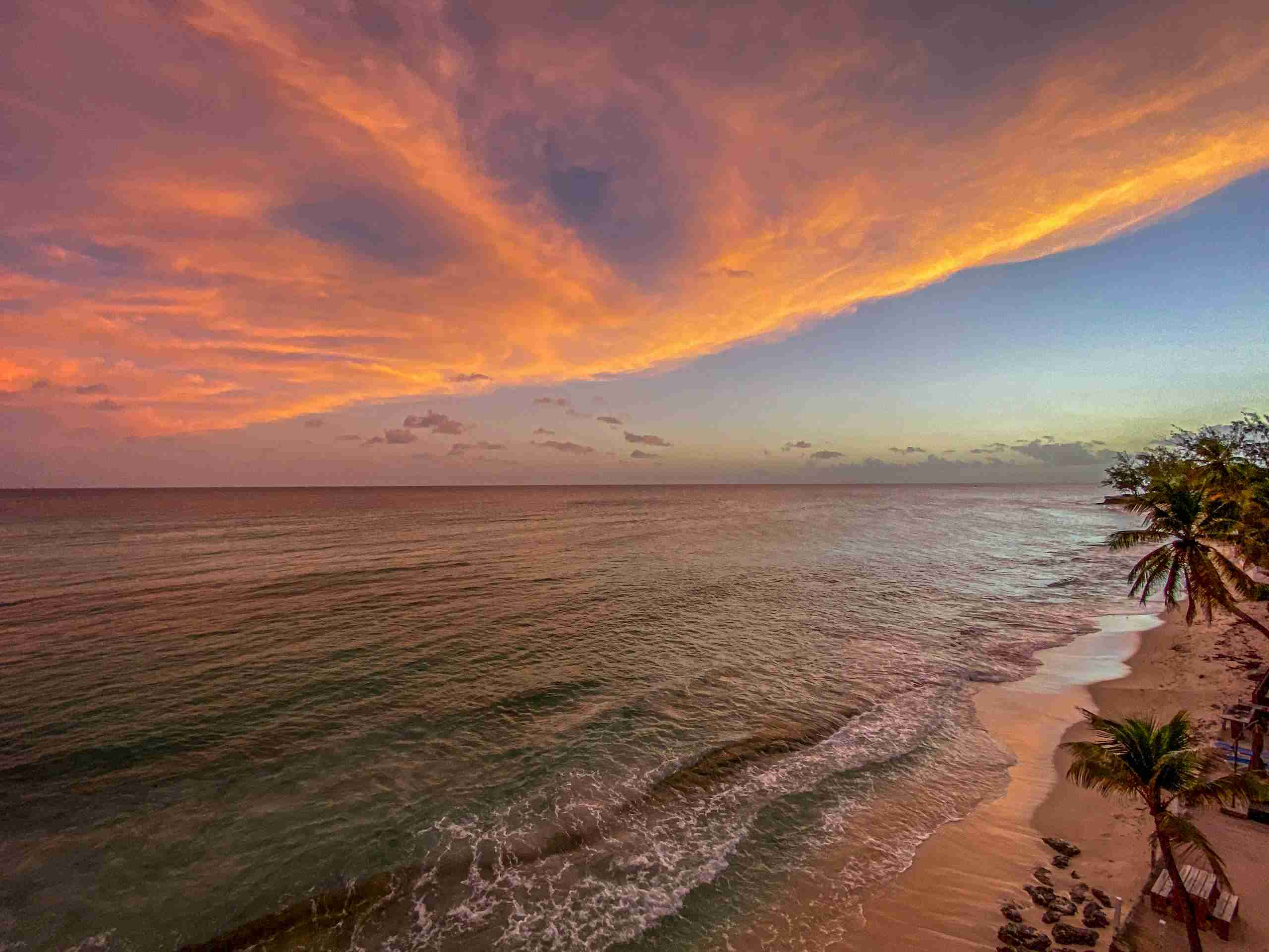 A breathtaking view of a tropical beach with vibrant sunset skies.